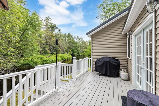 24 Dragon Back Rd, Naples, ME 04055 - wooden terrace with french doors, area for grilling, and a water view