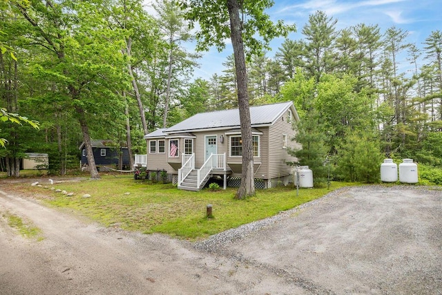 24 Dragon Back Rd, Naples, ME 04055 - view of front of property with a metal roof and view of scattered trees