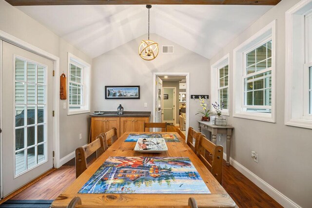 24 Dragon Back Rd, Naples, ME 04055 - dining area featuring a chandelier, lofted ceiling, and wood finished floors