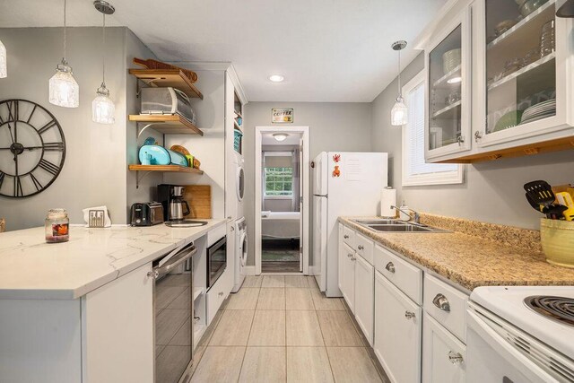 24 Dragon Back Rd, Naples, ME 04055 - kitchen with estacked washer and dryer, healthy amount of natural light, open shelves, glass insert cabinets, and recessed lighting