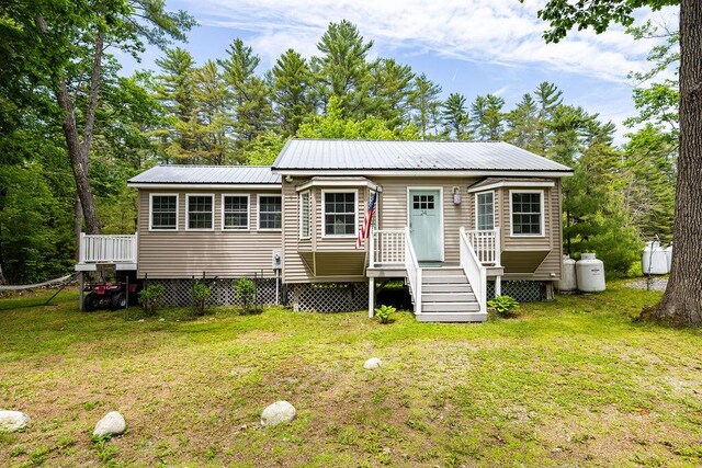 24 Dragon Back Rd, Naples, ME 04055 - view of front of house featuring a front lawn and a metal roof