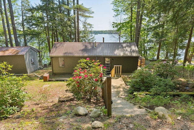 8 S Heritage Woods Ln, Winthrop, ME 04364 - back of property with metal roof, a water view, and an outbuilding