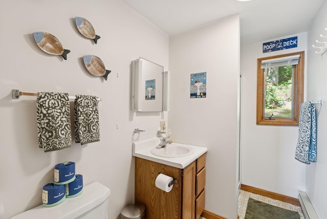 8 S Heritage Woods Ln, Winthrop, ME 04364 - bathroom featuring vanity, toilet, a baseboard radiator, and baseboards