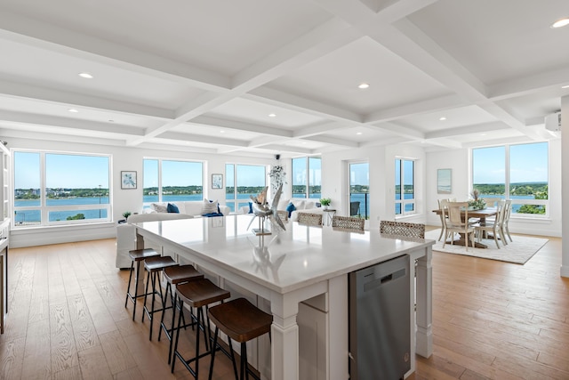 218 Washington Ave Unit 401, Portland, ME 04101 - kitchen with open floor plan, dishwasher, hardwood / wood-style flooring, coffered ceiling, and a breakfast bar area