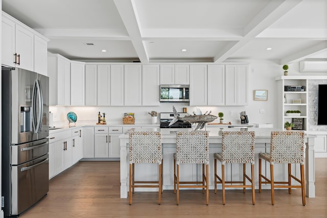 218 Washington Ave Unit 401, Portland, ME 04101 - kitchen featuring stainless steel appliances, coffered ceiling, a kitchen island, beamed ceiling, and white cabinets