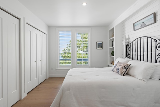 218 Washington Ave Unit 401, Portland, ME 04101 - bedroom featuring wood finished floors, recessed lighting, and two closets