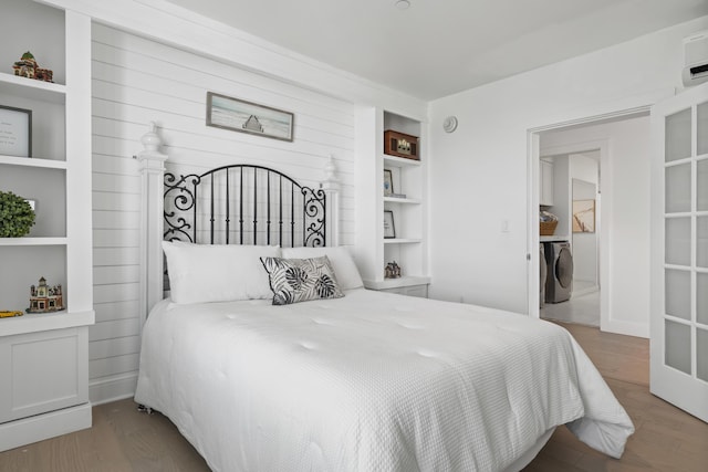218 Washington Ave Unit 401, Portland, ME 04101 - bedroom featuring wood finished floors and washer / clothes dryer