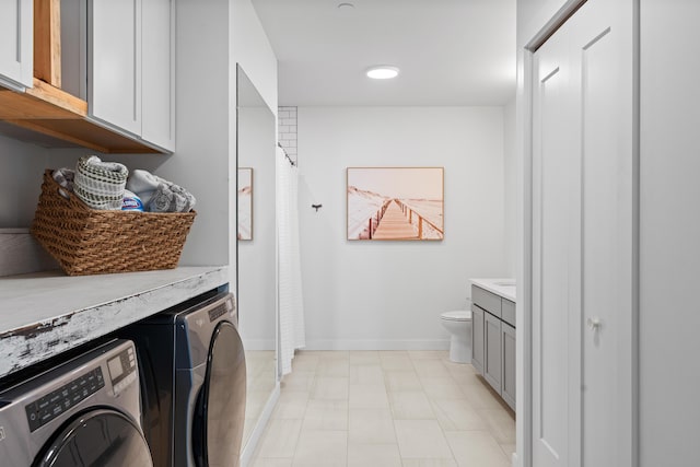 218 Washington Ave Unit 401, Portland, ME 04101 - washroom featuring washer and clothes dryer and cabinet space