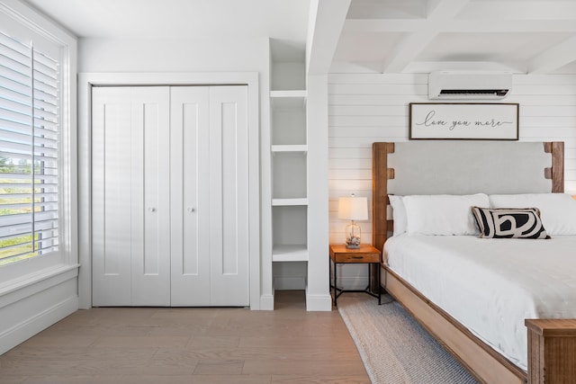 218 Washington Ave Unit 401, Portland, ME 04101 - bedroom featuring an AC wall unit, a closet, and beam ceiling