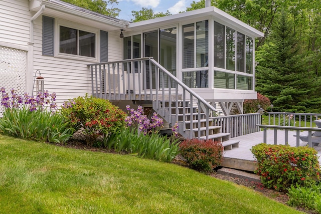 369 Grove St, Lewiston, ME 04240 - back of house featuring a sunroom, a wooden deck, and a lawn