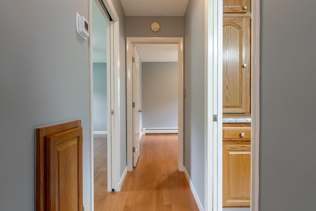369 Grove St, Lewiston, ME 04240 - corridor featuring baseboard heating and light wood-type flooring
