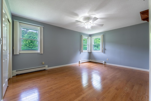 369 Grove St, Lewiston, ME 04240 - unfurnished room featuring baseboard heating, plenty of natural light, ceiling fan, and a textured ceiling
