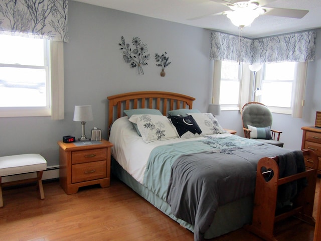 369 Grove St, Lewiston, ME 04240 - bedroom featuring multiple windows, light wood-style flooring, and a ceiling fan