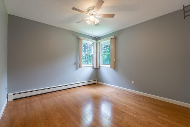 369 Grove St, Lewiston, ME 04240 - spare room with baseboard heating, light wood-style floors, ceiling fan, and baseboards