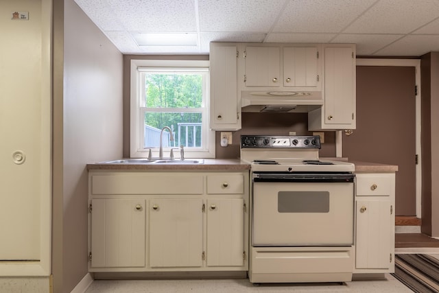 369 Grove St, Lewiston, ME 04240 - kitchen featuring electric stove, under cabinet range hood, a sink, a drop ceiling, and light countertops