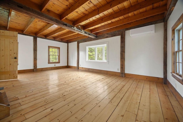 427 Haley Rd, Kittery, ME 03905 - spare room featuring an AC wall unit, light wood-style floors, plenty of natural light, baseboards, and wooden ceiling with exposed beams