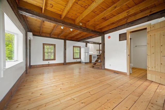 427 Haley Rd, Kittery, ME 03905 - empty room with light wood-style floors, wood ceiling with exposed beams, a wall unit AC, baseboards, and stairway