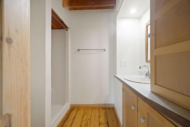 427 Haley Rd, Kittery, ME 03905 - bathroom featuring hardwood / wood-style flooring, vanity, baseboards, and a shower