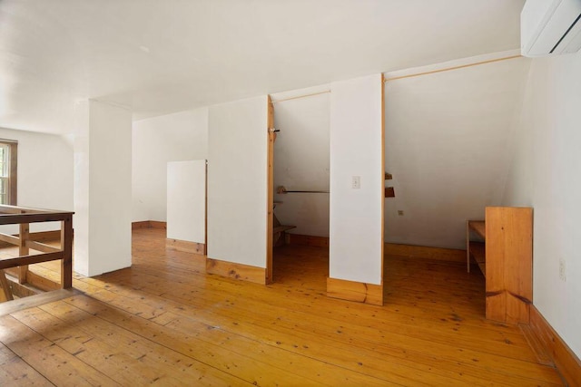 427 Haley Rd, Kittery, ME 03905 - empty room with an AC wall unit and light wood-style flooring