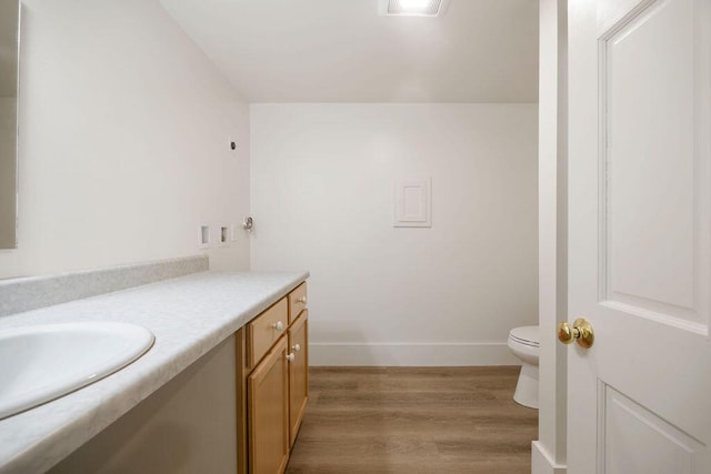 427 Haley Rd, Kittery, ME 03905 - bathroom with toilet, vanity, wood finished floors, and baseboards