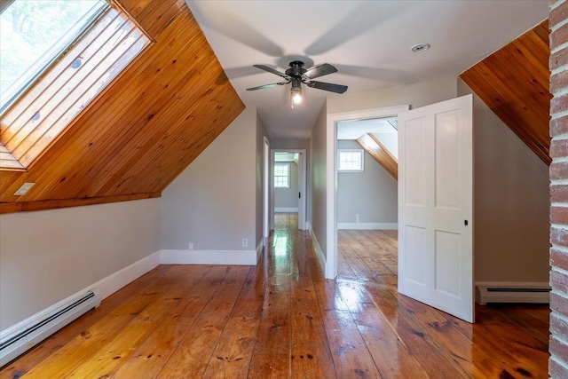 15 Feylers Corner Rd, Waldoboro, ME 04572 - bonus room featuring a baseboard radiator, baseboard heating, a ceiling fan, a skylight, and hardwood / wood-style floors