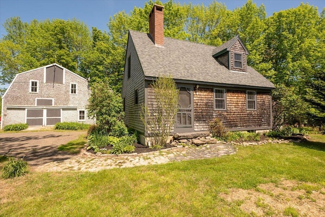 15 Feylers Corner Rd, Waldoboro, ME 04572 - view of front of property with a shingled roof, a front yard, a chimney, and a garage