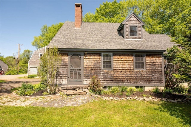 15 Feylers Corner Rd, Waldoboro, ME 04572 - view of front of property featuring a shingled roof, a front yard, a chimney, and a garage