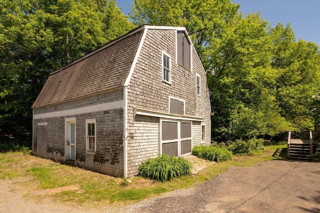 15 Feylers Corner Rd, Waldoboro, ME 04572 - view of home's exterior with an attached garage, a wooden deck, and a gambrel roof