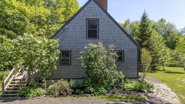 15 Feylers Corner Rd, Waldoboro, ME 04572 - view of home's exterior with a chimney, stairway, and a yard