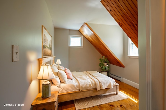 15 Feylers Corner Rd, Waldoboro, ME 04572 - bedroom featuring a baseboard radiator, wood finished floors, and vaulted ceiling