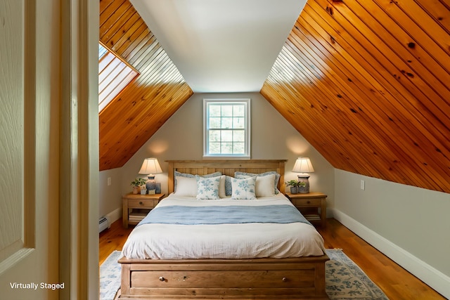 15 Feylers Corner Rd, Waldoboro, ME 04572 - bedroom with baseboard heating, wood finished floors, and vaulted ceiling