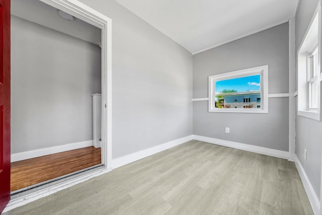 181 Webster St, Lewiston, ME 04240 - unfurnished bedroom featuring wood finished floors, multiple windows, and baseboards