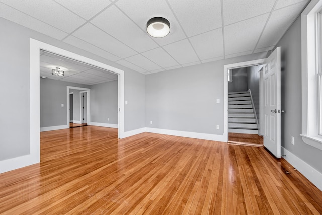 181 Webster St, Lewiston, ME 04240 - unfurnished room with stairs, light wood finished floors, baseboards, and a drop ceiling