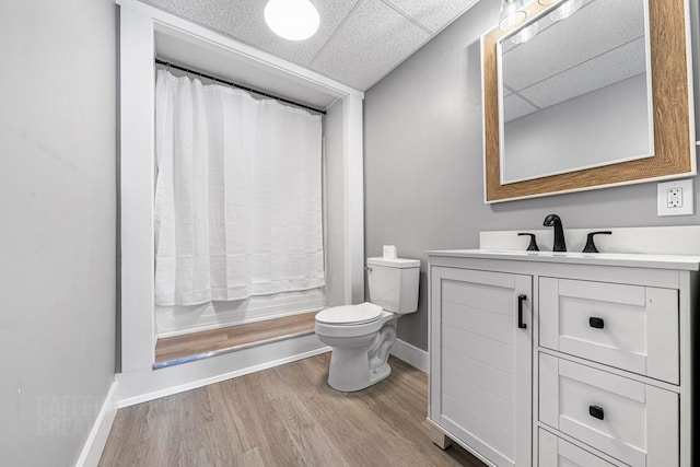 181 Webster St, Lewiston, ME 04240 - full bath with baseboards, a paneled ceiling, vanity, toilet, and wood finished floors