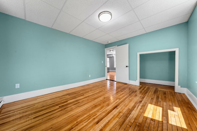 181 Webster St, Lewiston, ME 04240 - unfurnished bedroom with hardwood / wood-style floors, a drop ceiling, and baseboards