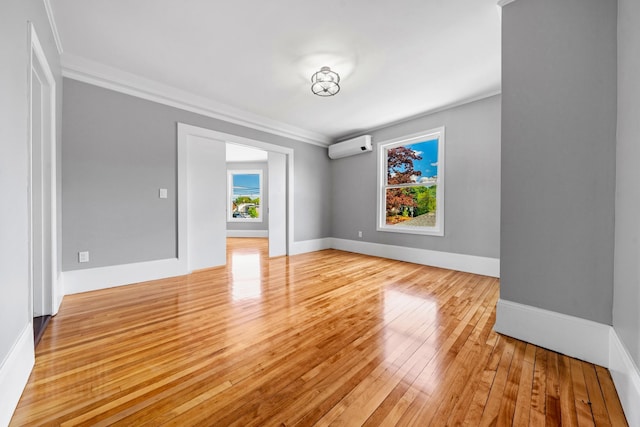 181 Webster St, Lewiston, ME 04240 - unfurnished room with a wall mounted AC, light wood-style floors, ornamental molding, and baseboards