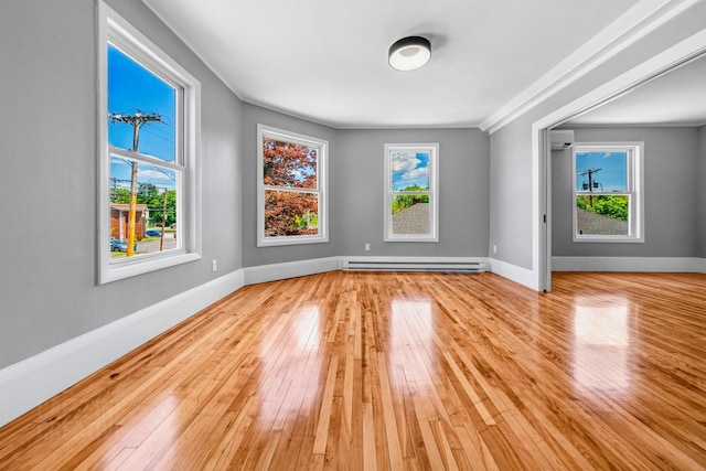 181 Webster St, Lewiston, ME 04240 - spare room with a baseboard heating unit, hardwood / wood-style flooring, and plenty of natural light