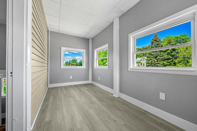 181 Webster St, Lewiston, ME 04240 - spare room with wood finished floors, a drop ceiling, and baseboards