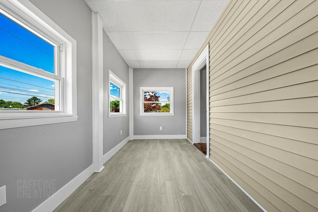 181 Webster St, Lewiston, ME 04240 - unfurnished room with a drop ceiling, wood finished floors, and baseboards