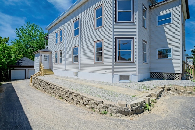 181 Webster St, Lewiston, ME 04240 - view of property exterior featuring entry steps, an outdoor structure, and a garage