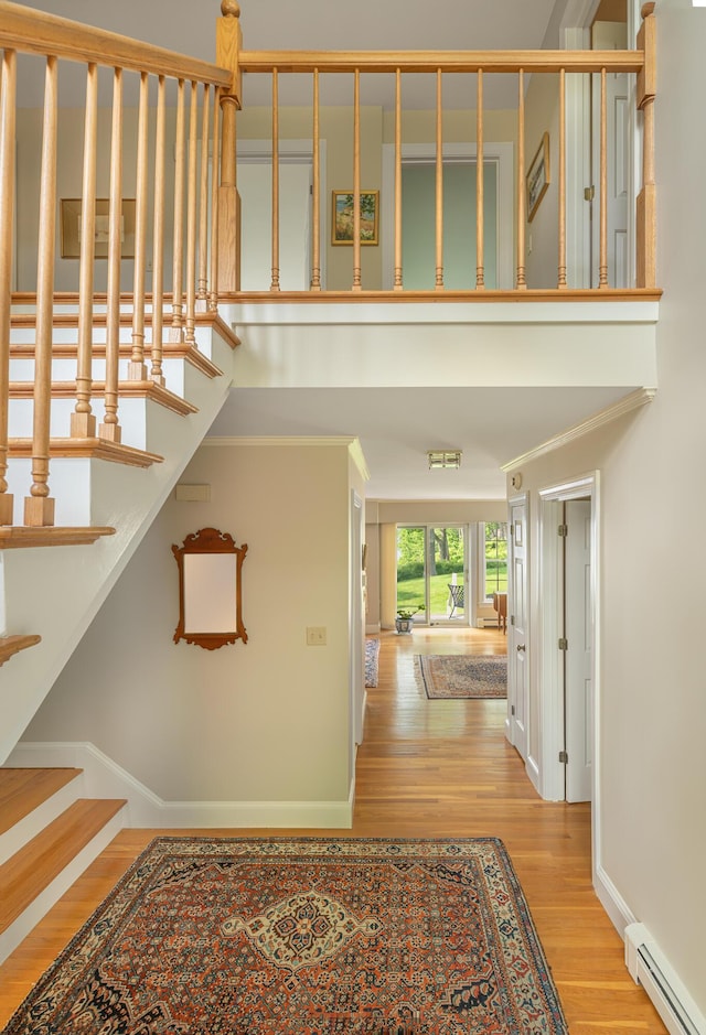 4 Roland Kimball Rd Unit 2, Freeport, ME 04032 - stairway featuring a baseboard radiator, wood finished floors, and crown molding