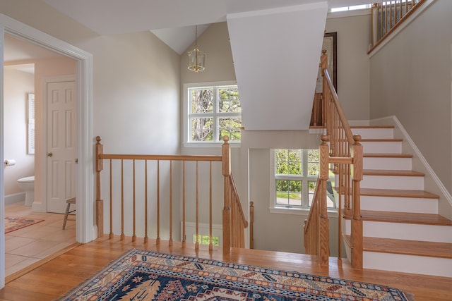 4 Roland Kimball Rd Unit 2, Freeport, ME 04032 - staircase with wood finished floors, healthy amount of natural light, a chandelier, and vaulted ceiling