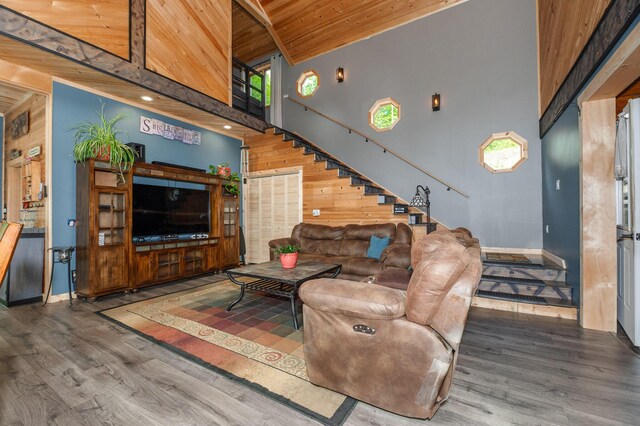 15 Doe Cir, Bingham, ME 04920 - living area with wooden ceiling with exposed beams, wood finished floors, high vaulted ceiling, stairway, and baseboards