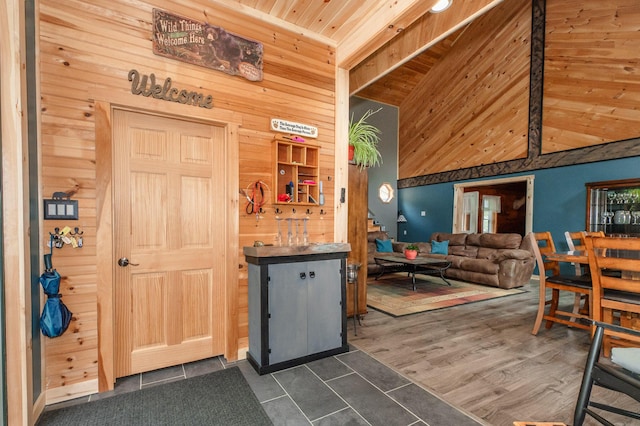 15 Doe Cir, Bingham, ME 04920 - kitchen with wood walls, dark tile patterned floors, wood ceiling, and high vaulted ceiling