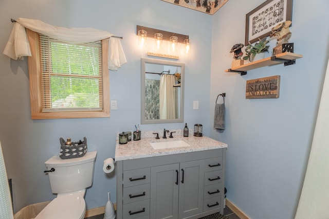 15 Doe Cir, Bingham, ME 04920 - bathroom featuring vanity, toilet, baseboards, and curtained shower