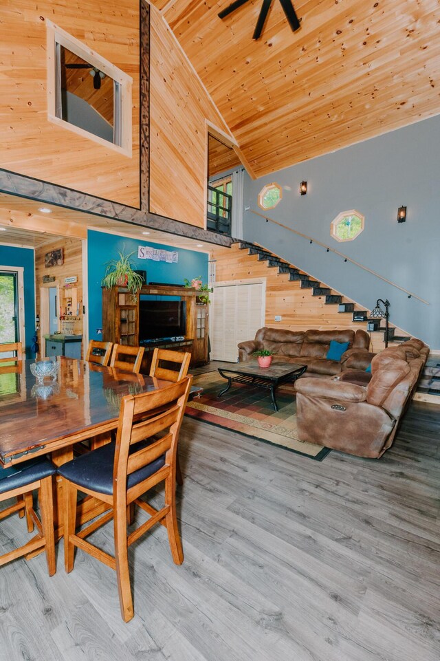 15 Doe Cir, Bingham, ME 04920 - dining space with wooden walls, vaulted ceiling, wood finished floors, wood ceiling, and healthy amount of natural light