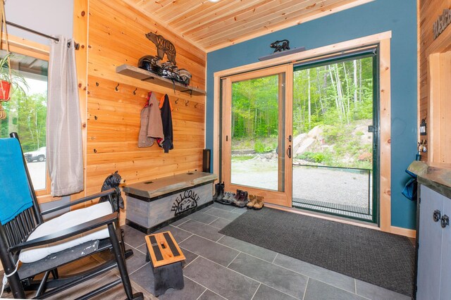 15 Doe Cir, Bingham, ME 04920 - mudroom featuring plenty of natural light, wooden walls, dark tile patterned flooring, and wood ceiling