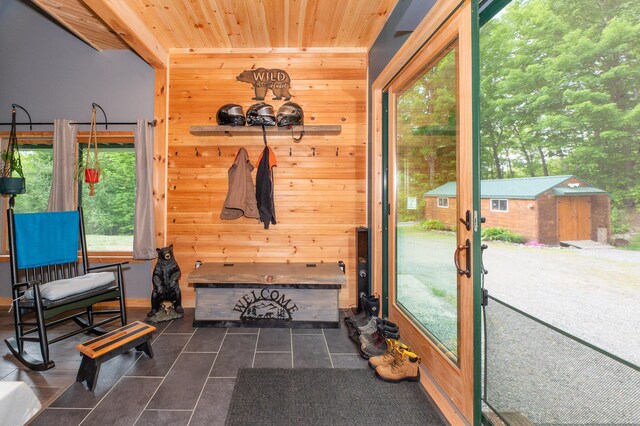 15 Doe Cir, Bingham, ME 04920 - mudroom featuring dark tile patterned flooring, wooden walls, wooden ceiling, and plenty of natural light