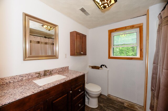 15 Doe Cir, Bingham, ME 04920 - full bath with wood finished floors, vanity, and toilet