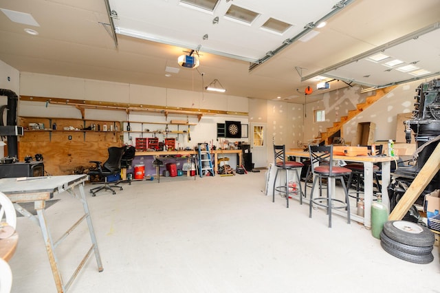 15 Doe Cir, Bingham, ME 04920 - garage with a workshop area and a garage door opener